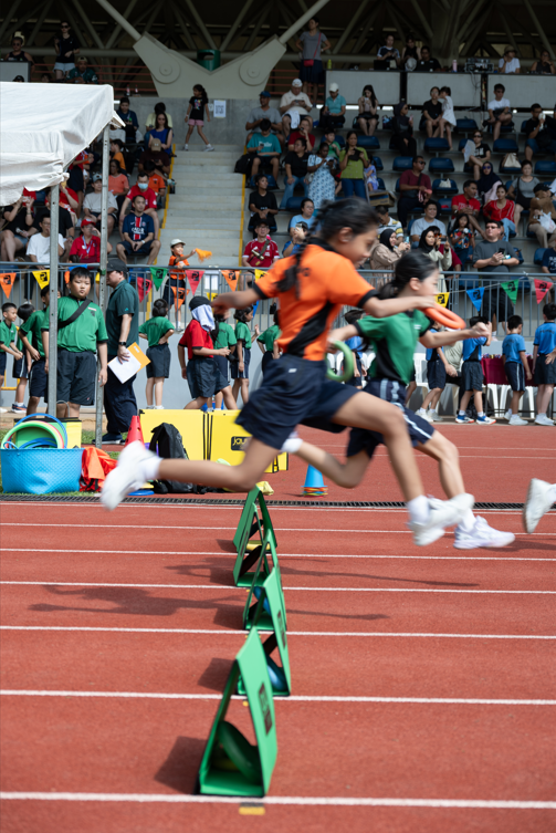 Student competing in a hurdles event.